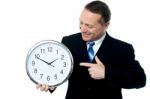 Smiling Man Holding A Clock In His Hands Stock Photo