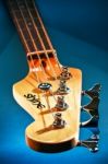 Close-up Electric Bass Guitar Head And Tuning Pegs Stock Photo