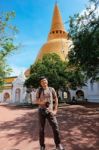 Tourist Man With Camera Standing In Front Og Thai Pagoda Temple Stock Photo