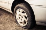 Close Up Flat Tire And Old Car On The Road Waiting For Repair Stock Photo
