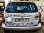 Old Car In Bordeaux Covered In A Multitude Of Stickers Stock Photo