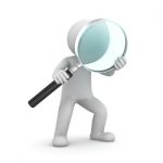 Figure Holding Magnifying Glass Stock Photo