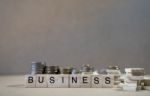 Business Word Written In Wooden Cube On Wood Table With Money Gr Stock Photo