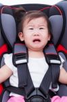 Girl Crying At Car-seat And Fasten Seat Belt Stock Photo