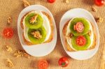 Toast With Kiwi, Cheese, Walnuts And Cherry Tomato Stock Photo