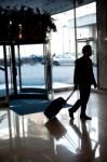 Man Entering Hotel With Luggage Stock Photo