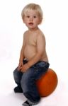 Little Boy On A Pumpkin Stock Photo