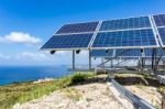 Solar Panels Near Blue Sea And Monastry Stock Photo