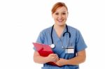 Young Female Nurse Holding Clipboard Stock Photo