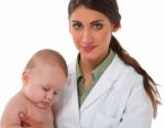 Confident Female Pediatrician Checking Baby Boy Stock Photo