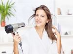 Woman Drying Hair At Home Stock Photo