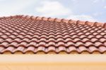 Roof Tiles And Rain Gutter Horizontal View Against Blue Sky Stock Photo