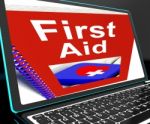 First Aid On Laptop Shows Medical Assistance Stock Photo