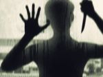Shadowy Figure With A Knife Behind Glass Stock Photo