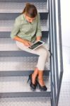 Woman Sitting Staircase Using Digital Tablet Stock Photo