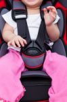 Girl Sitting At Carseat And Fasten Seat Belt Stock Photo