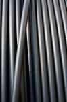 Close-up Of Black Electricity Cable Verticla On A Spool Stock Photo
