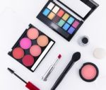 Makeup Cosmetics, Brushes And Other Essentials On White Background Top View. Beauty Flat Lay Concept Stock Photo