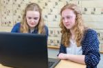 Two Dutch Teenage Girls Working At Computer In Chemistry Lesson Stock Photo