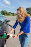 Dutch Woman Refueling Car Tank With Gasoline Stock Photo