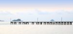 Long Wooden Pier Port On Morning Beach Stock Photo