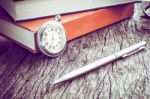 Pocket Watch And Book With Pen, On Old Textured Wood. Vintage Style Stock Photo