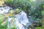 The Water Flowing Over Rocks And Trees Down A Waterfall At Huay Mae Khamin Waterfall National Park ,kanchana Buri In Thailand Stock Photo