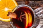 Mulled Wine And Spices On Weathered Wooden Table Stock Photo