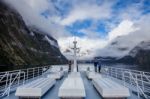 Milfordsound New Zealand-august 30 : Tourist On Roof Of Milfordsound Cruise With High Mountain Background On August30, 2015 In Milford Sound Fiordland National Park New Zealand Stock Photo