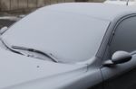 Parked Car Covered With The First Snow In Winter Stock Photo