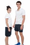 Teen Couple In Sportswear Posing Casually Stock Photo