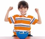 Young Boy Shows His Strength By Raising His Arms Stock Photo