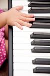 Baby Hand On Piano Stock Photo