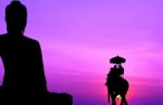 Silhouette Elephant With Tourist In Front Of Big Buddha At Sunse Stock Photo