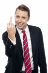 Displeased Businessman Showing Middle Finger Politely Stock Photo