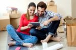 Young Couple With Digital Tablet In Their New Home Stock Photo