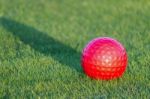 Red Golf Ball On Grass Stock Photo