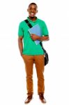 African Male Holding Book And Bag Stock Photo