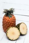 Fresh Azores Pineapple Fruit Isolated On A White Wooden Background Stock Photo