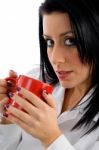 Side View Of Female Doctor Holding Mug On White Background Stock Photo