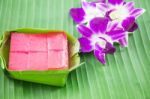 Kind Of Thai Sweetmeat, Multi Layer Sweet Cake (kanom Chan) On Banana Leaf With Orchid Flower Stock Photo