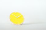 The Yellow Clock And White Background Stock Photo