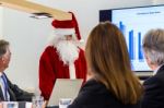 Female Santa Claus Presenting In Business Meeting Stock Photo