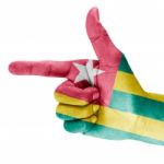 Togo Flag On Shooting Hand Stock Photo