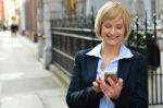 Businesswoman Using Her Smart Phone Stock Photo