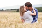 Happy Young Couple Hugging And Kissing Each Other Stock Photo