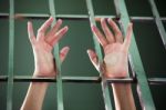 Prisoner Hands In Jail As Background Stock Photo