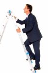 Business Man Climbing On Ladder Stock Photo