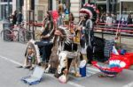 Buskers Dressed As American Red Indians Making Music In Milan Stock Photo