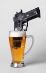 Pistol In Beer Glass Stock Photo